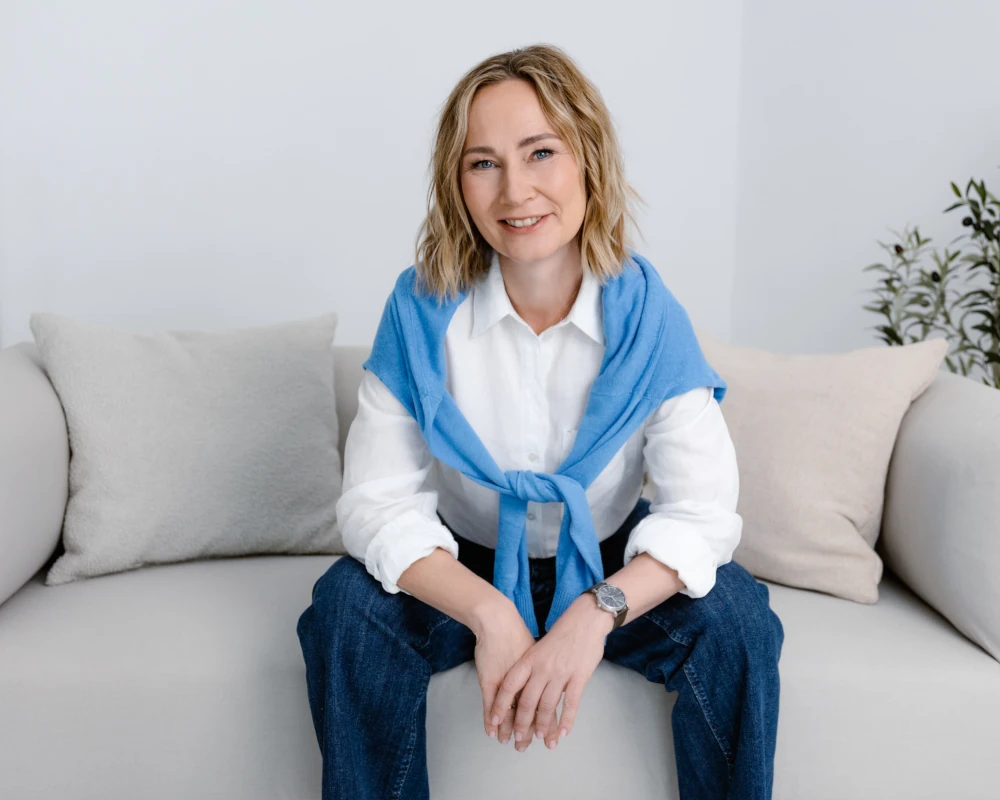 Agata Kalinowska, ICF-certified burnout coach, smiling outdoors in natural light